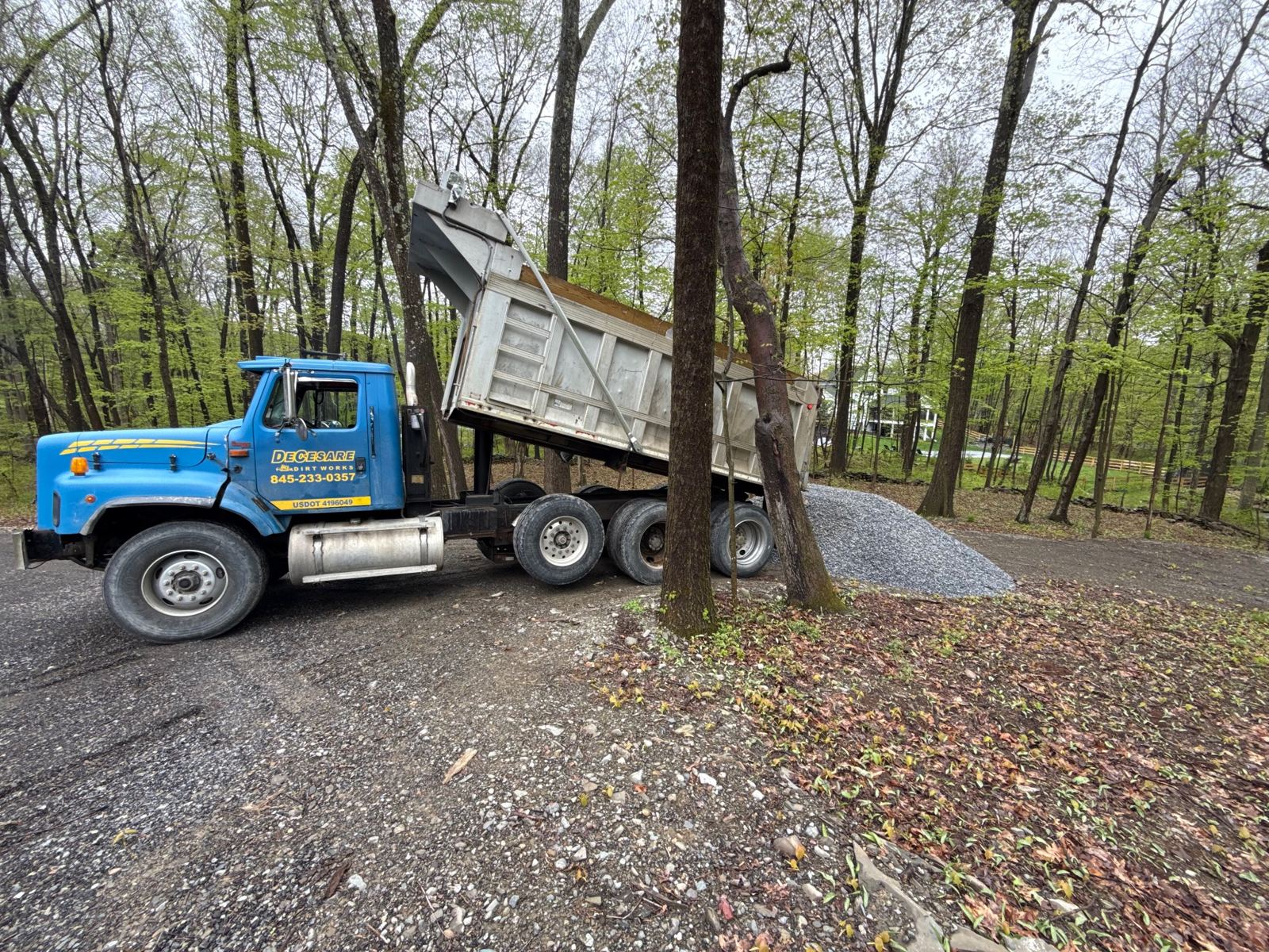 Dump truck delivering stone